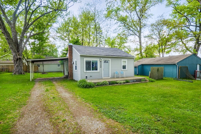 4120 Bunker Ave, West Bloomfield, MI 48323 - view of front facade with dirt driveway, a front yard, a chimney, and an attached carport
