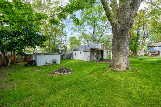 4120 Bunker Ave, West Bloomfield, MI 48323 - view of yard featuring an outdoor fire pit, an outbuilding, and a storage shed