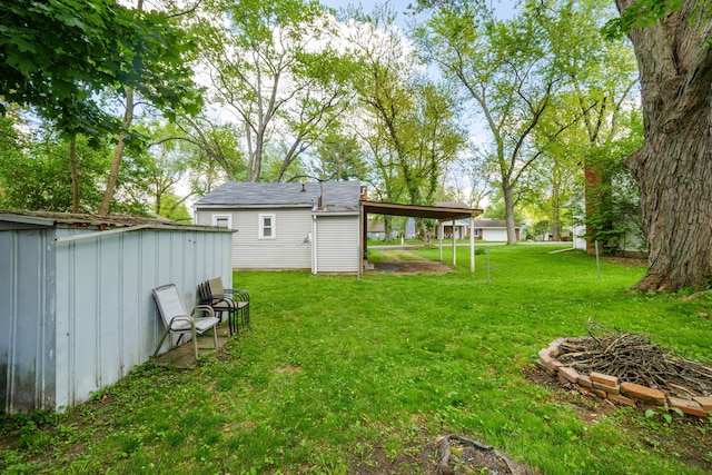 4120 Bunker Ave, West Bloomfield, MI 48323 - view of grassy yard with an outbuilding, a storage shed, and a carport