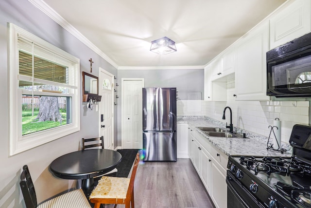 4120 Bunker Ave, West Bloomfield, MI 48323 - kitchen with freestanding refrigerator, gas stove, a sink, dark wood-style floors, and decorative backsplash
