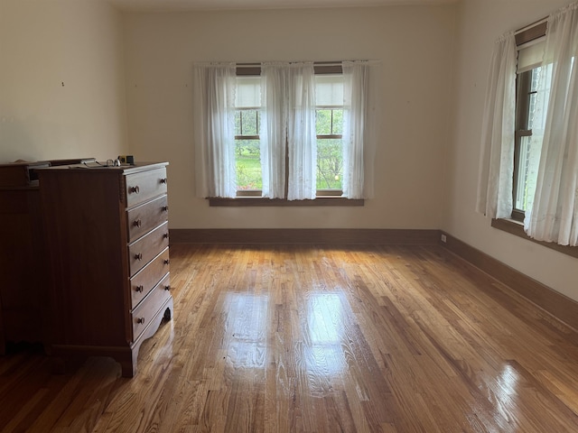1627 S M-52 Hwy, Owosso, MI 48867 - unfurnished bedroom with wood finished floors and baseboards