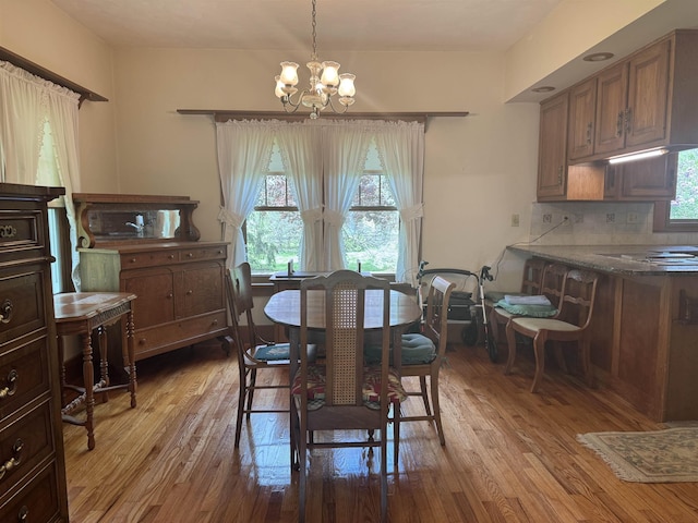 1627 S M-52 Hwy, Owosso, MI 48867 - dining room with light wood finished floors, plenty of natural light, and a chandelier