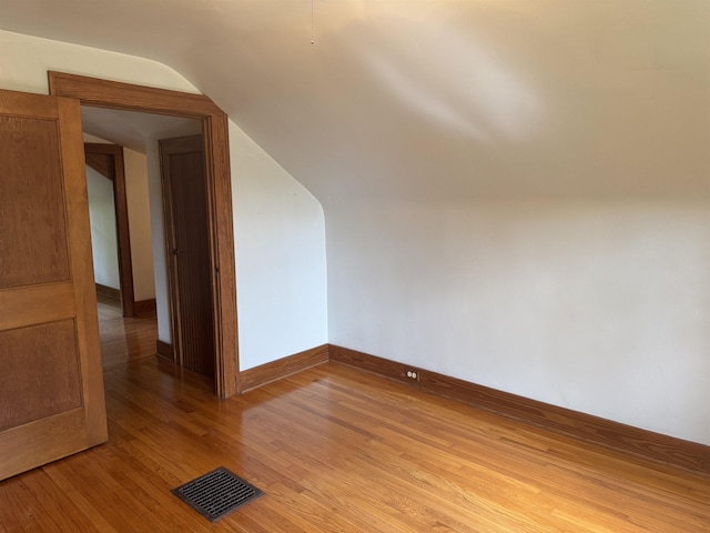 1627 S M-52 Hwy, Owosso, MI 48867 - additional living space featuring vaulted ceiling, light wood finished floors, and baseboards