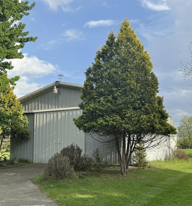1627 S M-52 Hwy, Owosso, MI 48867 - view of property exterior with a garage, an outbuilding, a pole building, and a yard