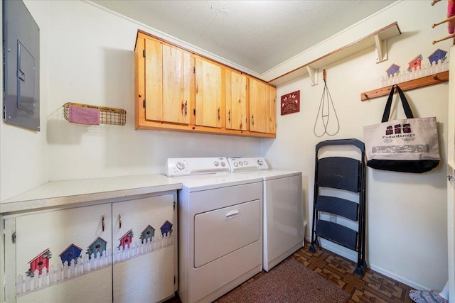 laundry room with cabinet space, washing machine and clothes dryer, and electric panel