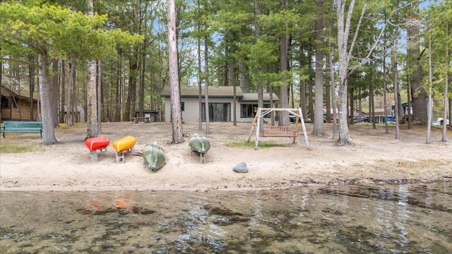 view of yard with view of wooded area