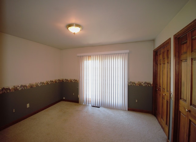 23049 27 Mile Rd, Ray, MI 48096 - unfurnished bedroom featuring multiple closets, light colored carpet, and baseboards