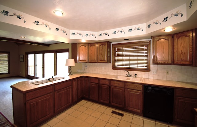 23049 27 Mile Rd, Ray, MI 48096 - kitchen featuring dishwasher, a sink, tile counters, a peninsula, and plenty of natural light