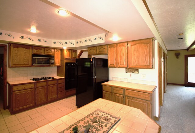 23049 27 Mile Rd, Ray, MI 48096 - kitchen featuring black appliances, tile countertops, backsplash, a textured ceiling, and light carpet