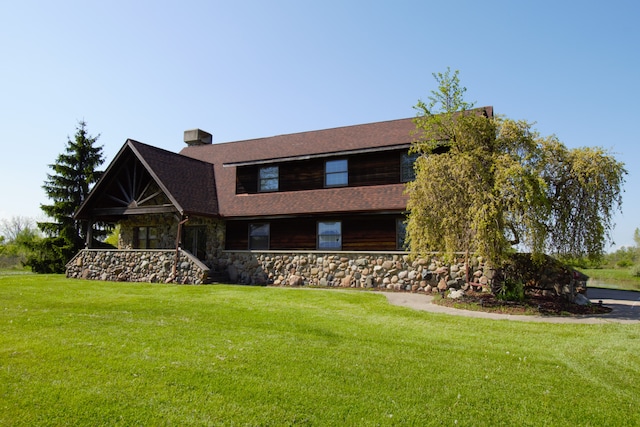 23049 27 Mile Rd, Ray, MI 48096 - view of front of home with a front lawn, a chimney, a porch, stone siding, and roof with shingles