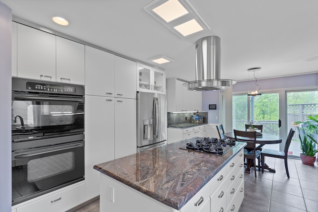 4958 Countryside Dr, West Bloomfield, MI 48323 - kitchen featuring black appliances, island range hood, hanging light fixtures, white cabinets, and dark stone countertops