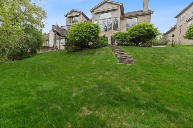 4958 Countryside Dr, West Bloomfield, MI 48323 - back of property featuring a chimney, a lawn, and brick siding
