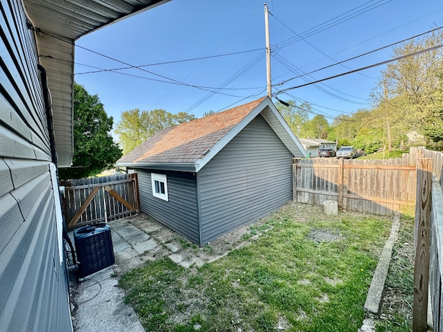 4915 Clarkston Rd, Clarkston, MI 48348 - view of side of home with a shingled roof, an outdoor structure, and central AC unit