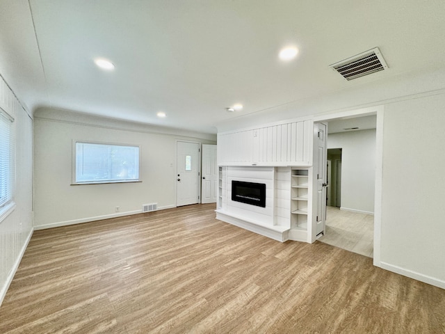 4915 Clarkston Rd, Clarkston, MI 48348 - unfurnished living room featuring light wood finished floors, baseboards, a glass covered fireplace, and recessed lighting