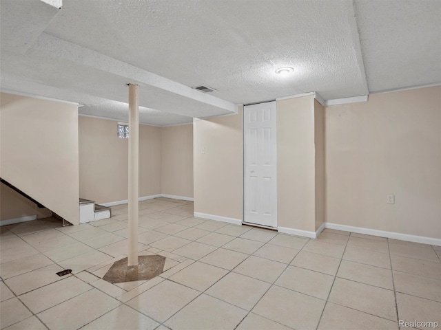 6010 Hartwell St, Dearborn, MI 48126 - finished basement with a textured ceiling, light tile patterned flooring, and baseboards