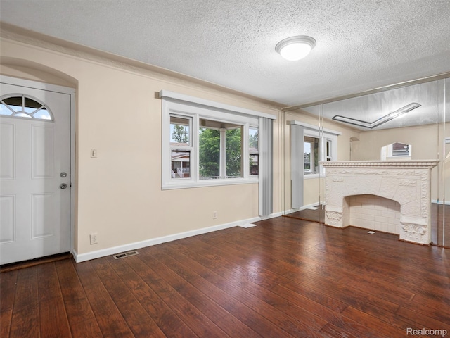 6010 Hartwell St, Dearborn, MI 48126 - unfurnished living room featuring hardwood / wood-style floors, baseboards, and a textured ceiling