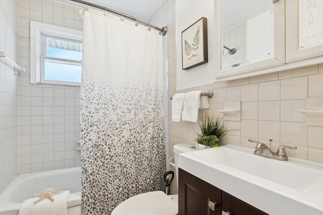 bathroom featuring toilet, tile walls, shower / tub combo, and vanity