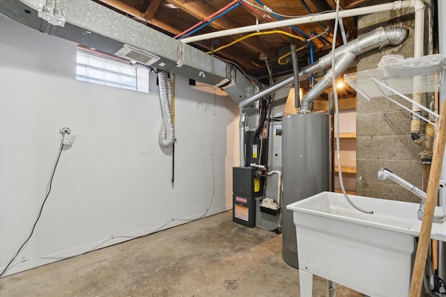 basement featuring water heater and a sink