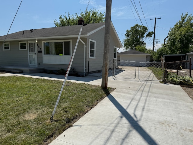 view of front of home with a garage and an outbuilding