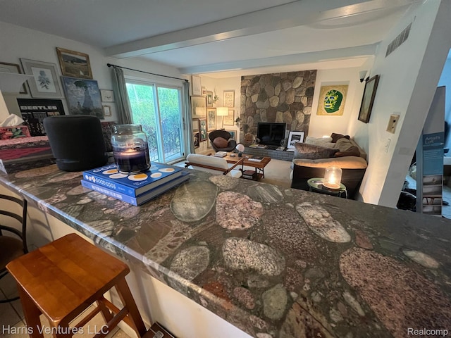 29430 Marimoor Dr, Southfield, MI 48076 - living room featuring beam ceiling and a fireplace