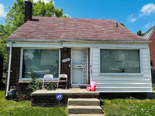 11329 Minock St, Detroit, MI 48228 - view of front facade featuring a chimney and brick siding