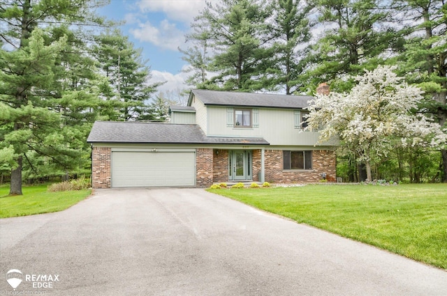 500 Granger Rd, Ortonville, MI 48462 - view of front facade with asphalt driveway, an attached garage, a front lawn, and a chimney