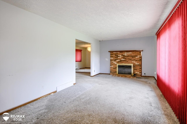 500 Granger Rd, Ortonville, MI 48462 - unfurnished living room featuring carpet flooring, a fireplace, a textured ceiling, and baseboards