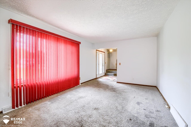500 Granger Rd, Ortonville, MI 48462 - unfurnished room with carpet flooring, a textured ceiling, and baseboards