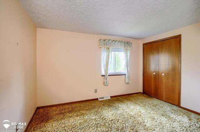 500 Granger Rd, Ortonville, MI 48462 - unfurnished bedroom featuring a closet, baseboards, a textured ceiling, and carpet