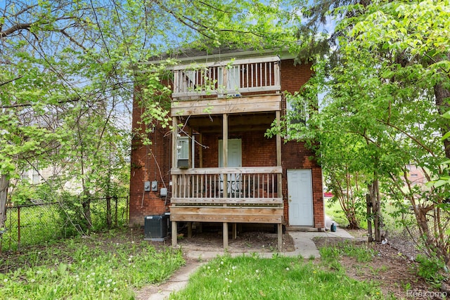 7501 Dunedin St, Detroit, MI 48206 - view of front of home with brick siding, central AC, and a wooden deck