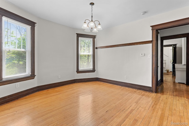 7501 Dunedin St, Detroit, MI 48206 - spare room with a chandelier, light wood finished floors, and baseboards