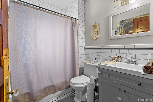 7501 Dunedin St, Detroit, MI 48206 - bathroom with tile walls, toilet, vanity, shower / bath combo with shower curtain, and tile patterned flooring