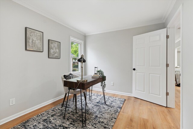home office featuring crown molding, light wood-style floors, and baseboards