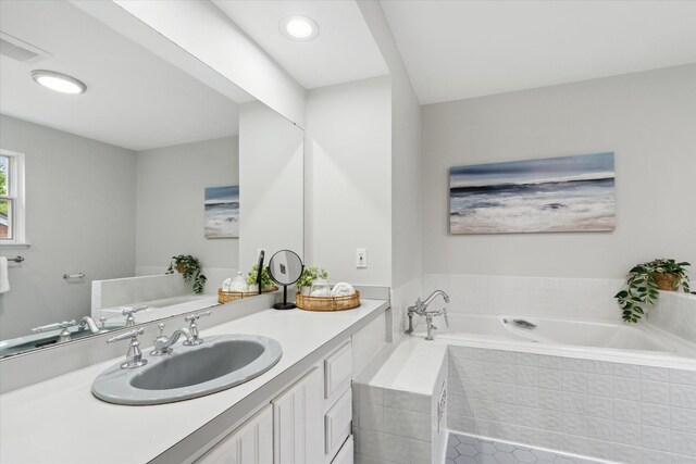 full bathroom with a garden tub, vanity, tile patterned floors, and recessed lighting