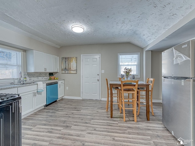 19106 Sylvia Ave, Romulus, MI 48174 - kitchen featuring appliances with stainless steel finishes, a sink, light wood-style flooring, white cabinetry, and a textured ceiling