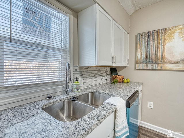 19106 Sylvia Ave, Romulus, MI 48174 - kitchen with stainless steel dishwasher, a sink, healthy amount of natural light, and white cabinetry