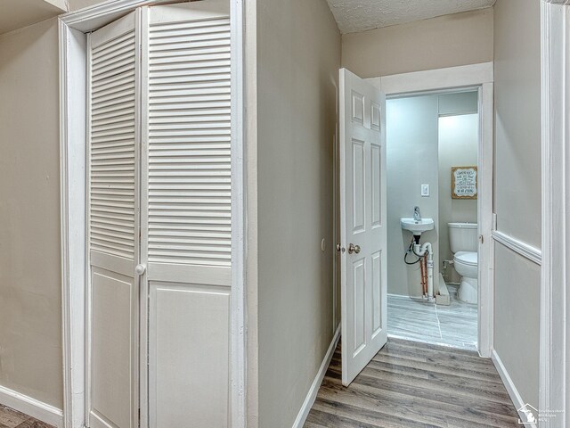 19106 Sylvia Ave, Romulus, MI 48174 - hallway featuring wood finished floors and baseboards