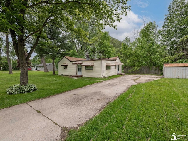 19106 Sylvia Ave, Romulus, MI 48174 - view of front of property with driveway, an outdoor structure, and a shed