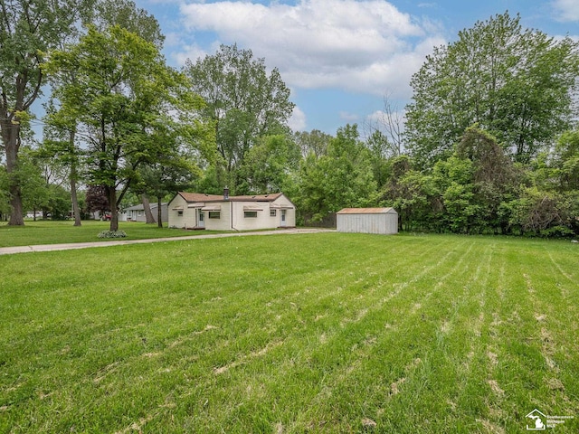 19106 Sylvia Ave, Romulus, MI 48174 - view of green lawn featuring a storage shed and an outdoor structure