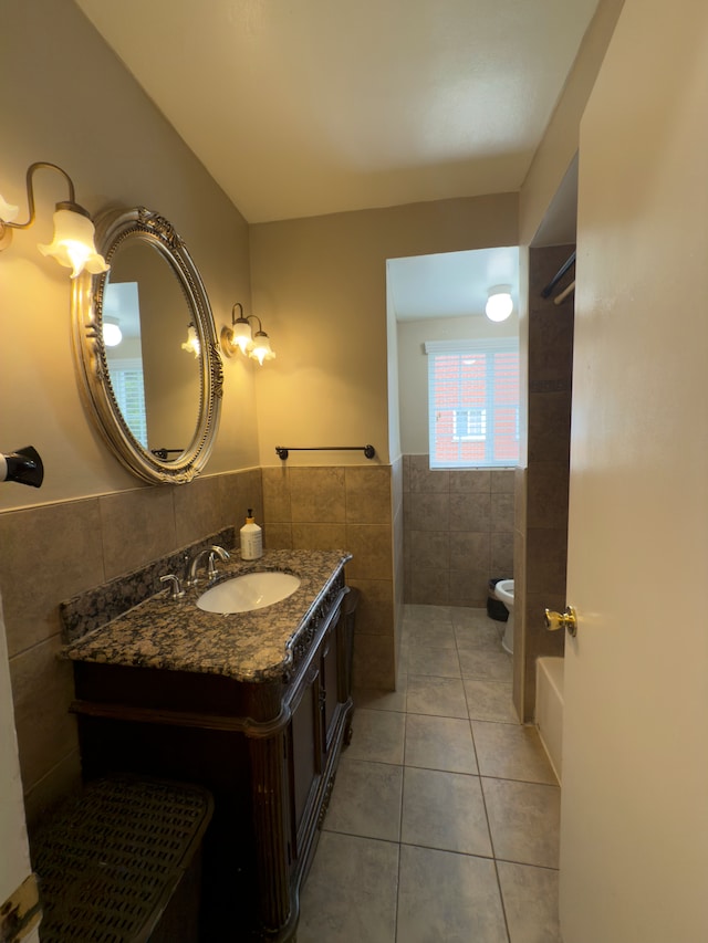 475 N Eton St Unit C7, Birmingham, MI 48009 - bathroom with tile walls, tile patterned flooring, wainscoting, vanity, and toilet