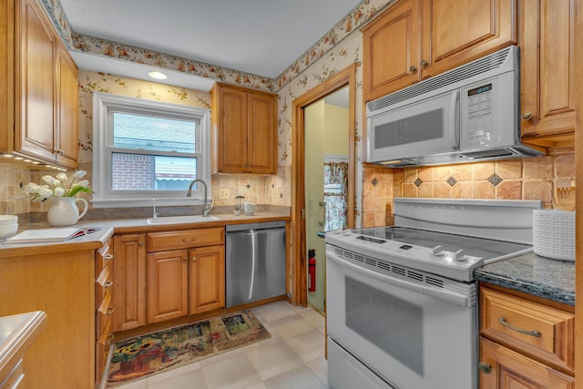 19150 Lexington, Redford, MI 48240 - kitchen with white appliances, a sink, decorative backsplash, wallpapered walls, and light flooring