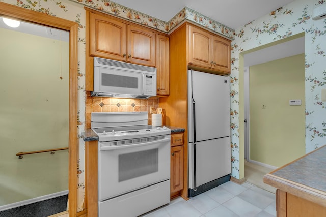 19150 Lexington, Redford, MI 48240 - kitchen with white appliances, wallpapered walls, brown cabinets, backsplash, and baseboards