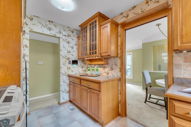 19150 Lexington, Redford, MI 48240 - kitchen with wallpapered walls, baseboards, light countertops, glass insert cabinets, and light carpet