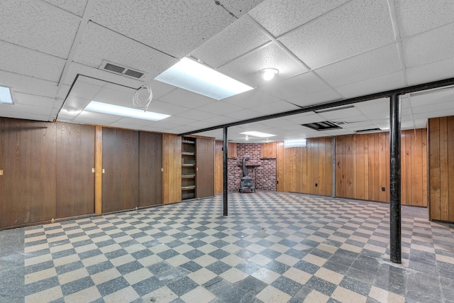 19150 Lexington, Redford, MI 48240 - finished basement with tile patterned floors, a drop ceiling, a wood stove, and wooden walls