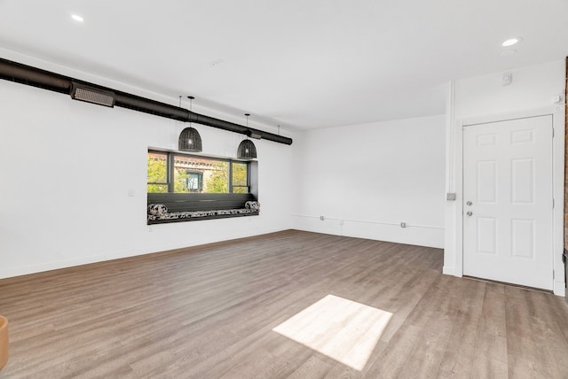436 E Milwaukee St Unit 8, Detroit, MI 48202 - unfurnished living room with wood finished floors, recessed lighting, and baseboards