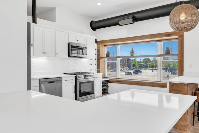 436 E Milwaukee St Unit 8, Detroit, MI 48202 - kitchen featuring appliances with stainless steel finishes, light countertops, tasteful backsplash, white cabinets, and recessed lighting