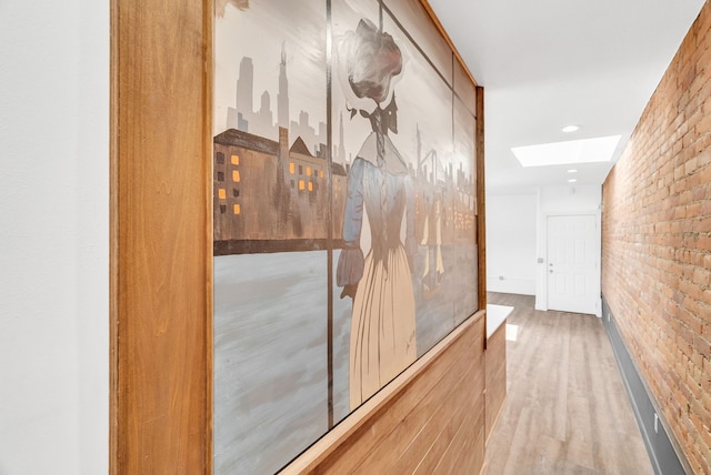 436 E Milwaukee St Unit 8, Detroit, MI 48202 - hallway featuring a skylight, brick wall, and wood finished floors