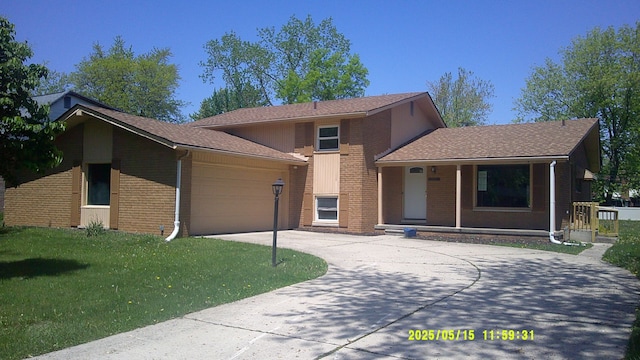 8240 Hampton Rd, Grosse Ile, MI 48138 - tri-level home featuring concrete driveway, a porch, brick siding, a garage, and a front yard