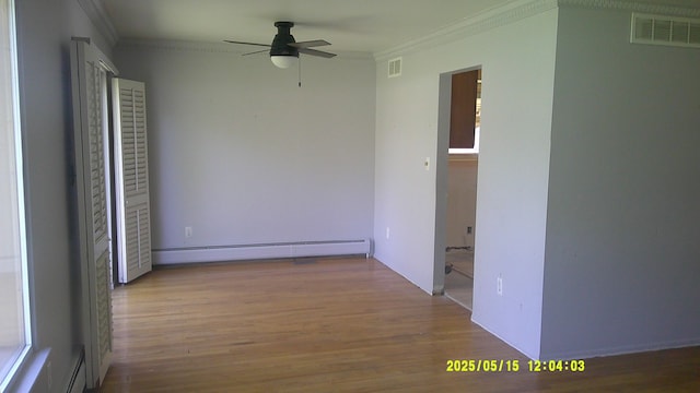 8240 Hampton Rd, Grosse Ile, MI 48138 - unfurnished room with baseboard heating, ornamental molding, a ceiling fan, and wood finished floors