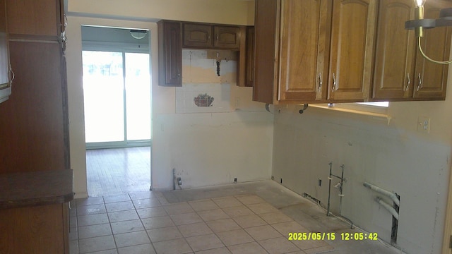 8240 Hampton Rd, Grosse Ile, MI 48138 - laundry room with light tile patterned flooring